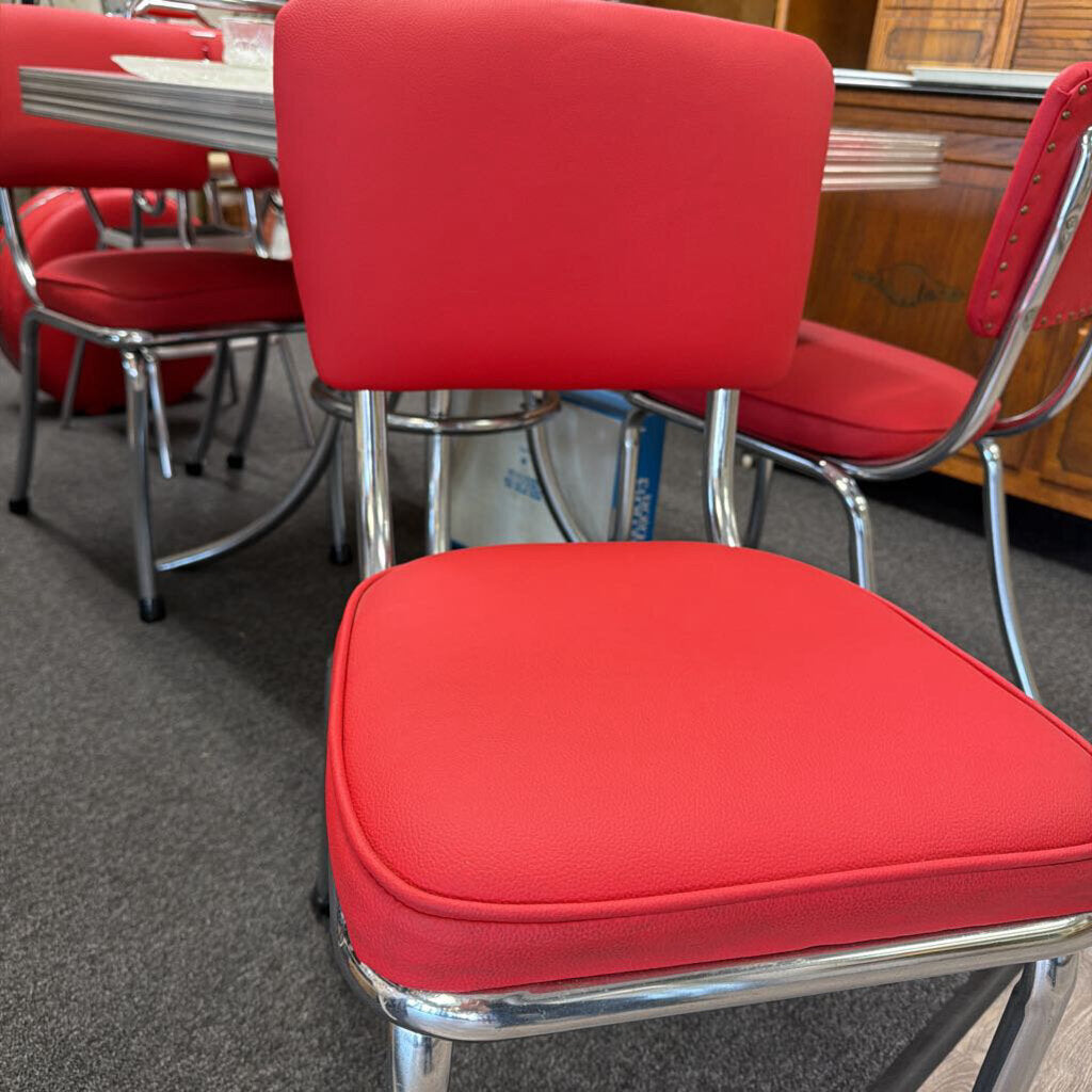 Grey Formica ice cube pattern Table with circular chrome base and four chairs