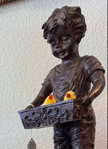 Brown resin boy with ducks