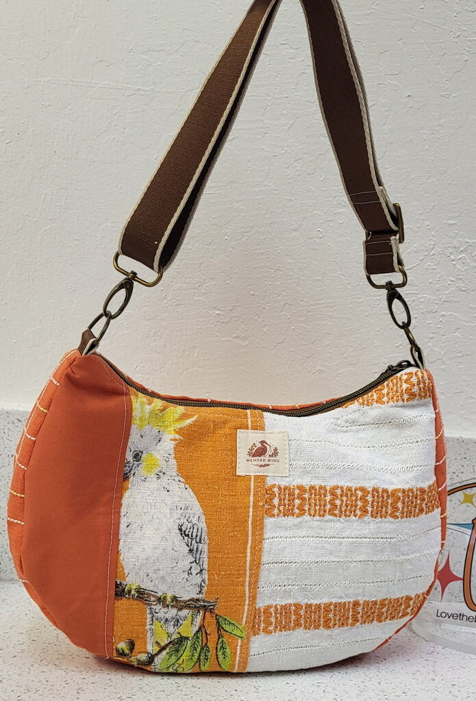 MENDED WING - Orange Parakeet Crescent Tablecloth purse